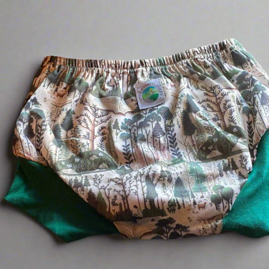 training shorts with embroidered trees, animals, and books