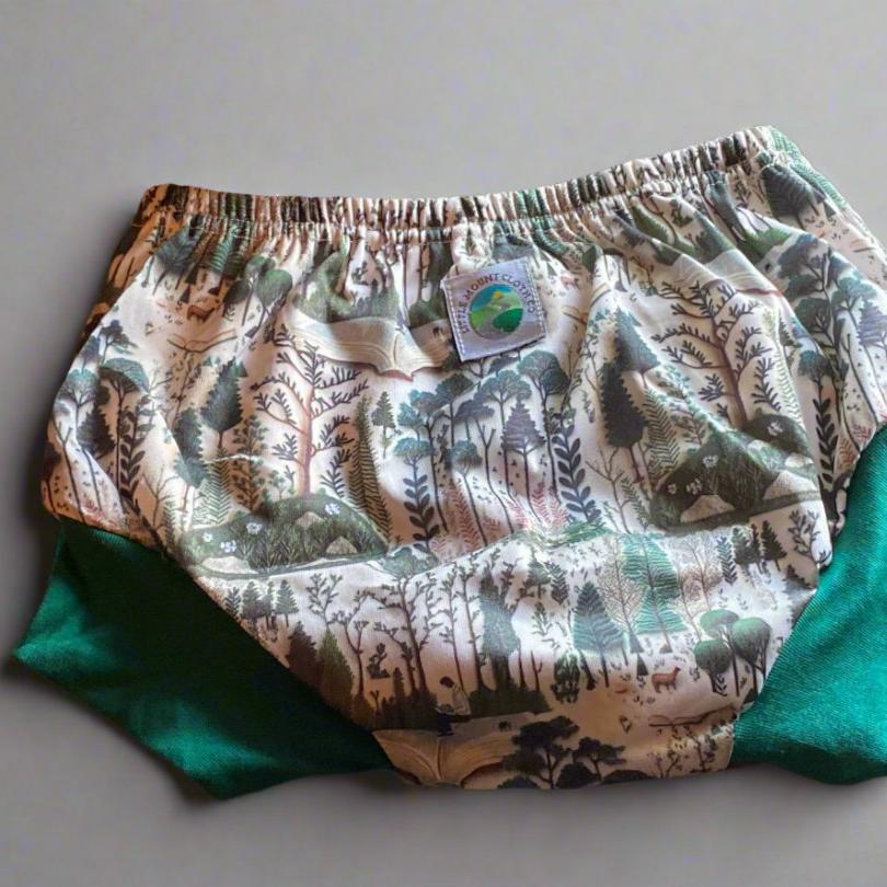 training shorts with embroidered trees, animals, and books